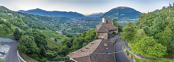 Wide panoramic view of Etsch Valley and Meran city with Castle Tyrol in the foreground