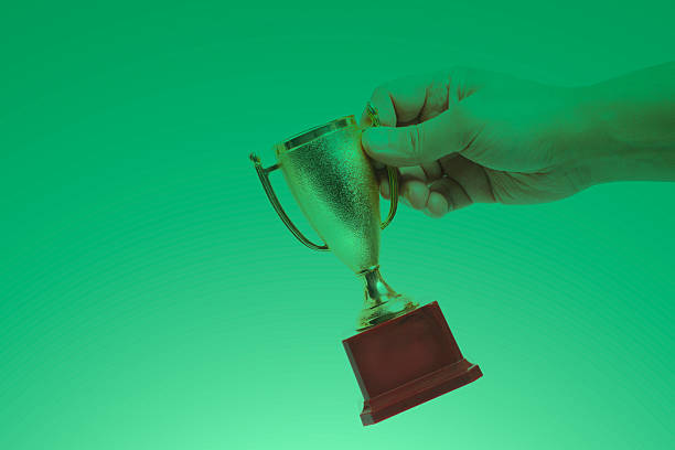 Growth Chart concept with trophy in hand isolated on white.