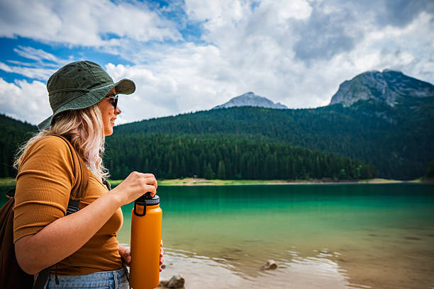 Female hiker enjoying peaceful moments by lake in the mountains
