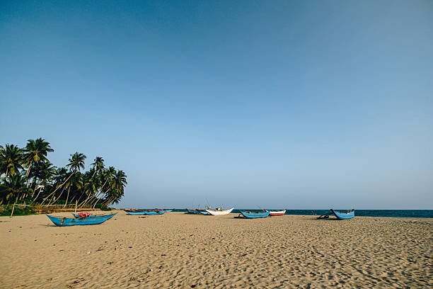 Fishing boat on beach at sunset, Galle