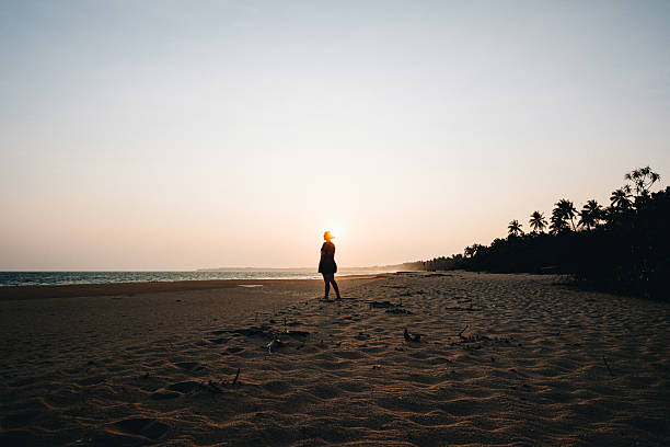 Young woman enjoys beach at sunset, Galle