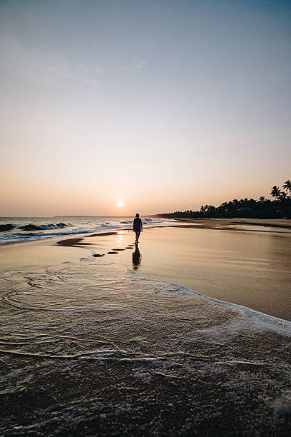 istock Young woman enjoys beach at sunset 2234884021