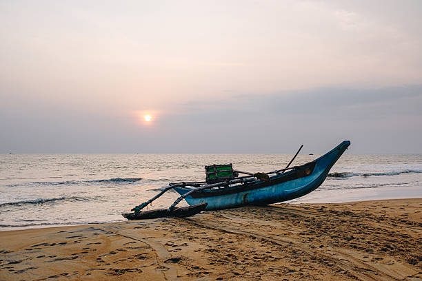 Fishing boat on beach at sunset, Galle