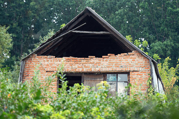 istock Old crumbling abandoned brick house with collapsed wall in rural area 2234884606
