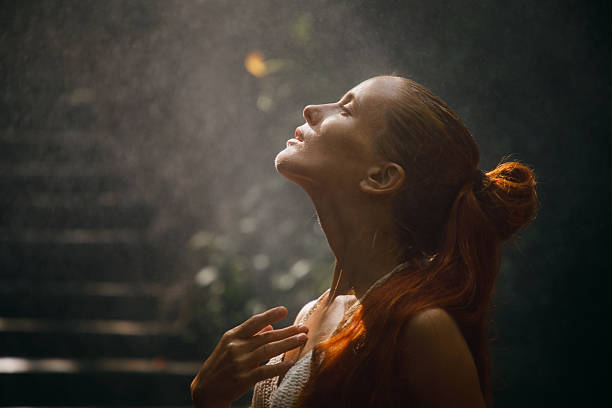 Serene portrait of a woman enjoying a tranquil moment under natural sunlight. The peaceful scene captures her connection with nature and conveys a sense of relaxation, mindfulness, and harmony.