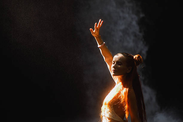istock Woman With Raised Hand Posing in Artistic Dramatic Lighting 2234884817