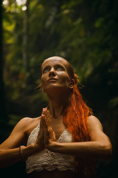 istock Young woman practicing meditation in nature surrounded by lush greenery 2234884951