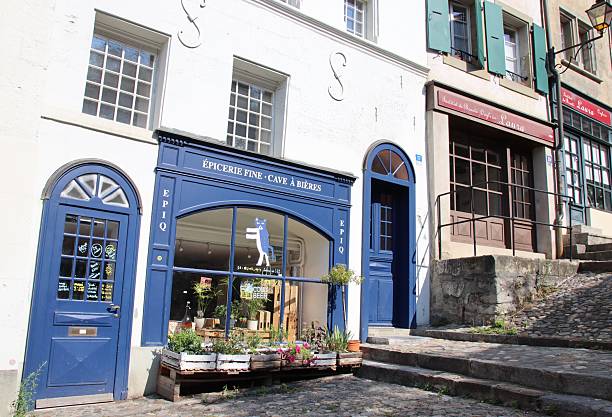 Lausanne, Switzerland - August 25, 2025:  Old shops and buildings near the wooden staircase leading up to Lausanne Cathedral