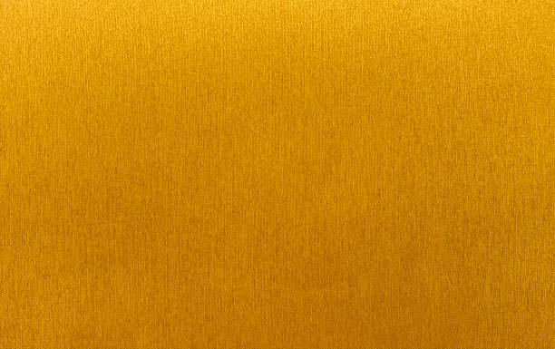 istock Vibrant, golden-yellow fabric with a subtle vertical weave texture. This high-quality, seamless textile background is perfect for creative projects, upholstery. 2234885437