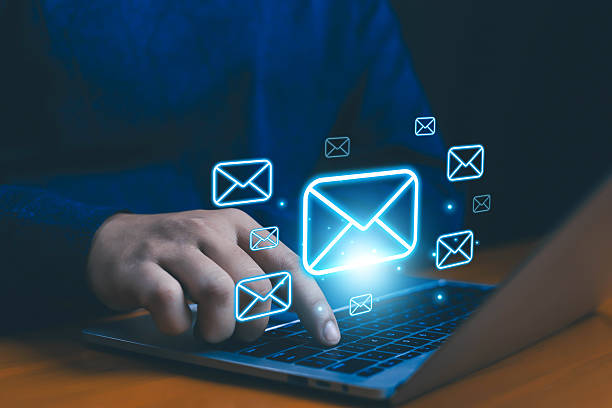 istock Digital email marketing concept with glowing envelope icons on a laptop, representing online communication, business messaging, newsletters, and customer engagement business mail, marketing, customer 2234886572