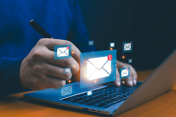 istock Email notification alert concept with glowing envelope icons on a laptop, symbolizing digital messaging, email marketing, business communication, and customer engagement tools. 2234886582