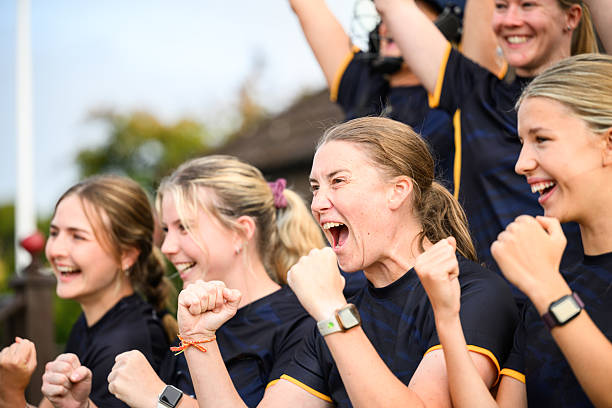 Close up women's sports team cheering together