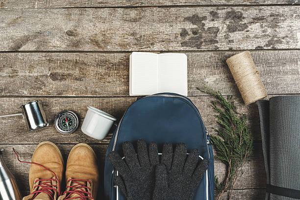 istock Backpack and hiking equipment on wooden background, top view 2234887301