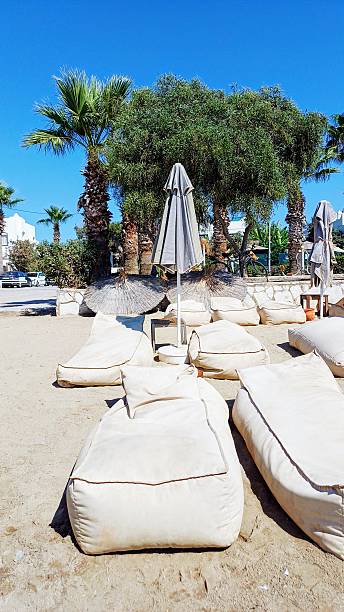 Beach holiday seaside sun loungers umbrellas