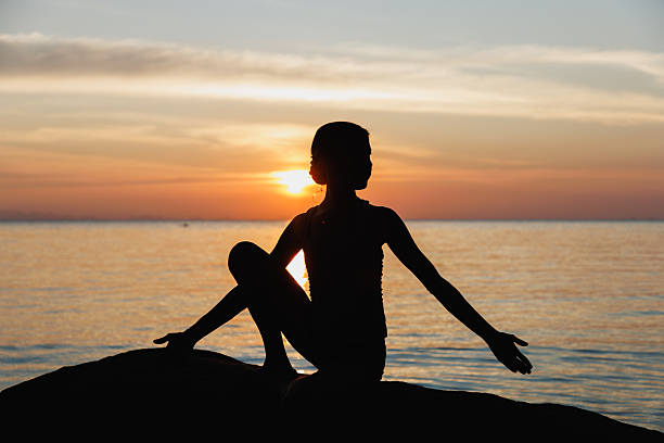 istock Peaceful meditation silhouette at sunset by the serene seaside 2234888071