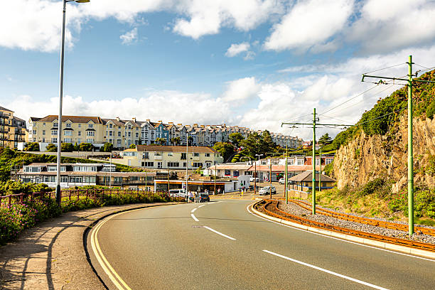 istock Road with a train track on the side Isle Of Man - 2234889761