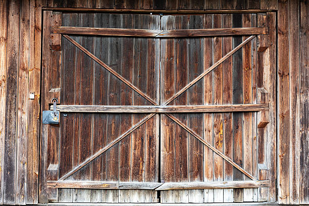istock Old wooden barn doors with diagonal braces and metal latch 2234890189