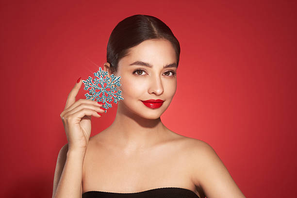 istock Beautiful young woman with glowing snowflake 2234895369