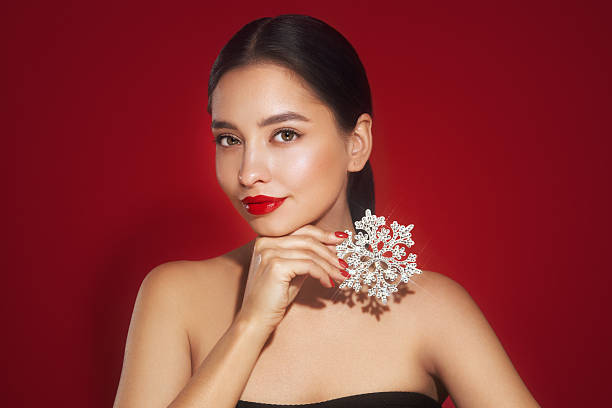 istock Beautiful young woman with glowing snowflake 2234895500