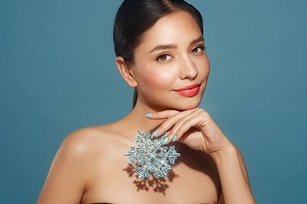 istock Beautiful young woman with glowing snowflake 2234895895