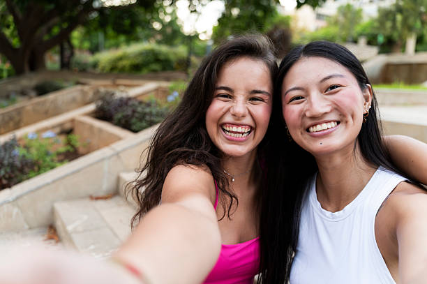 istock Two young women smiling at the camera 2234895994