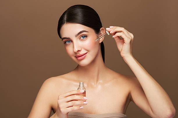 istock Young beautiful woman applying face serum 2234897241