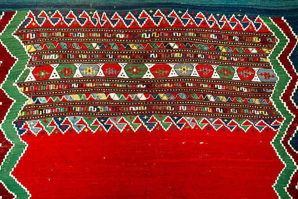 Traditional Anatolian kilim featuring geometric motifs, red base color, and cultural textile heritage patterns. The flatwoven carpet represents handwoven craftsmanship and historic design elements.