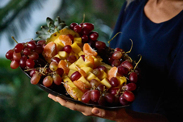 Fresh fruit platter with pineapple, grapes, oranges, and sliced mango