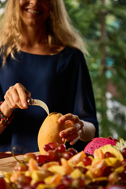 istock Person Preparing Fresh Fruit Salad Outdoors for a Healthy Meal 2234898634