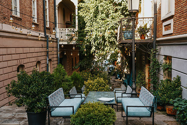 istock Inviting outdoor seating area surrounded by greenery in a charming alley 2234900961