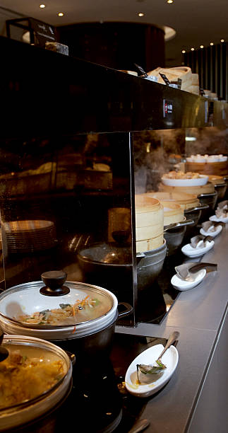istock Restaurant buffet with variety of steaming dishes and dim sum baskets 2234902580