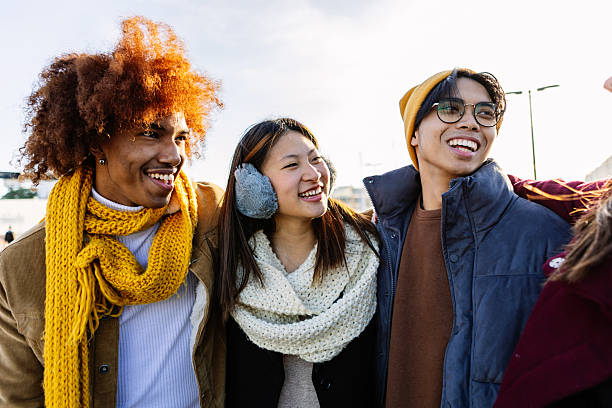 Diverse group of gen z happy friends having fun together on winter vacation stock photo