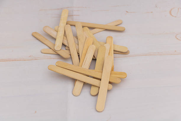 istock Wooden craft sticks pile on light background - natural popsicle sticks for DIY projects, handmade crafts, ice cream sticks 2234905313