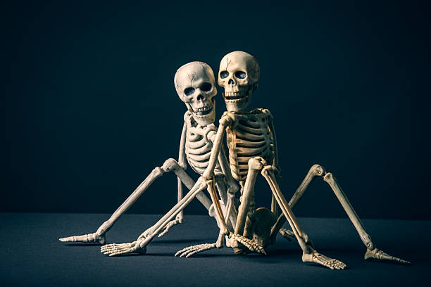 istock Back to Back Skeleton Couple on Black 2234905450