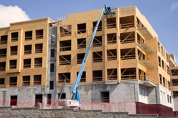istock New construction large condo building with crane 2234905745