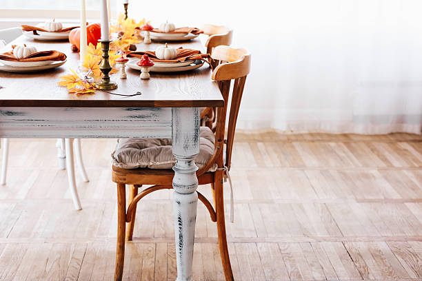 istock Decorative autumn dining setup with warm colors and rustic charm in a cozy interior space 2234906188