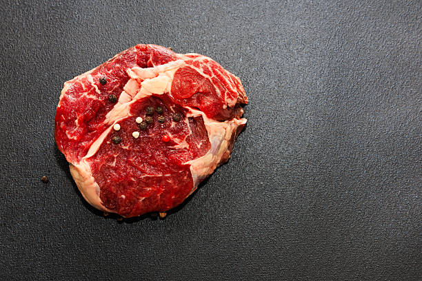 Fresh raw steak ready for seasoning and cooking in a kitchen setting