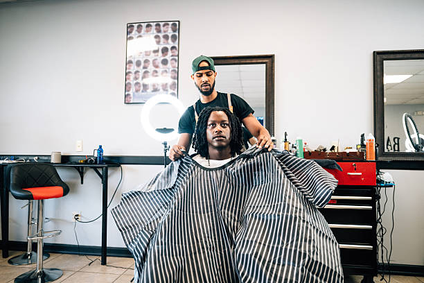 Wide shot of Barber working on client's haircut