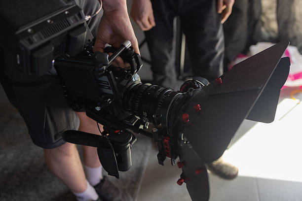 istock Filming process. Cameraman holding camera in his right hand outside. 2234912246