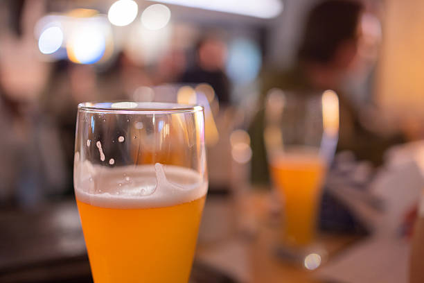 istock Glasses of light beer with barley on a pub background. 2234912257