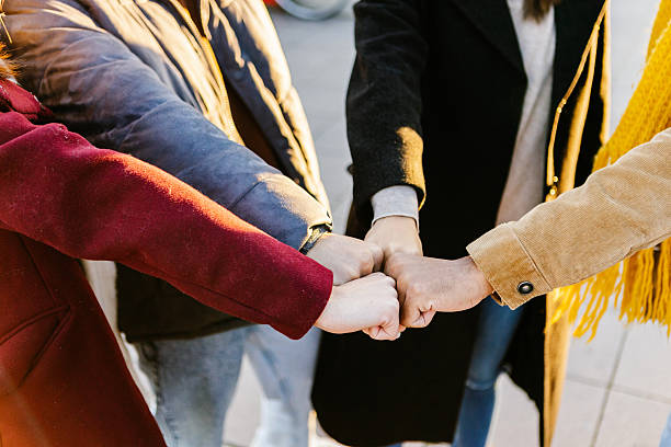 istock Close up group of young students stacking hands together 2234913709