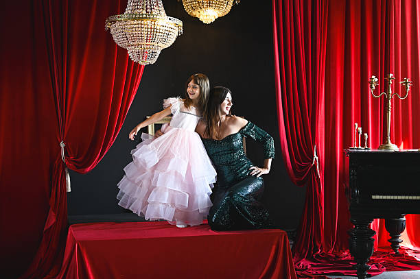 istock Mother and daughter posing on stage in elegant dresses 2234915934
