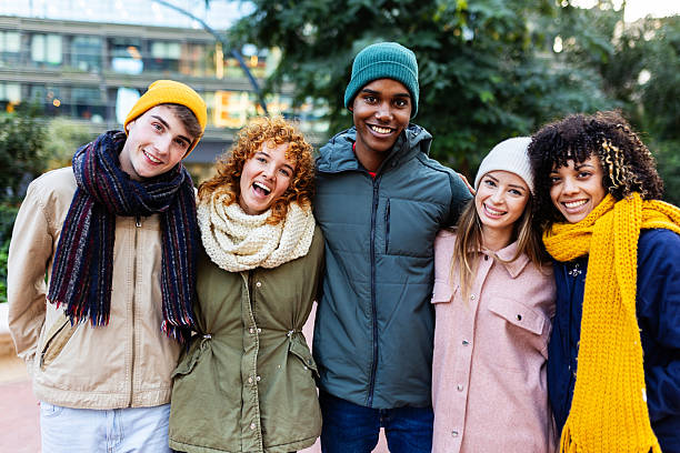 istock Multiracial friends embracing winter outdoors together 2234916422