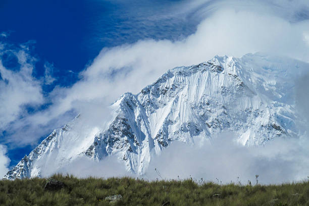 Standing atop a snow-covered Nepalese mountain, the person gazes out at the breathtaking panoramic view, feeling a sense of awe and accomplishment at having conquered such a formidable peak. The crisp, thin air and the stunning vistas stretching out in all directions provide a humbling reminder of the power and majesty of nature.