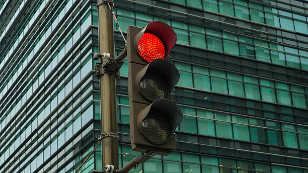 istock Red traffic light in front of a modern building in Japan 2234920257