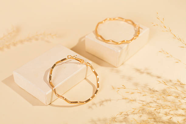 istock Golden earrings with decor on color background 2234922131