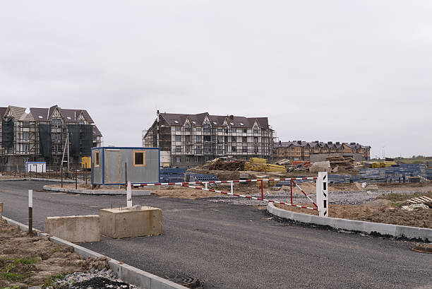 The ongoing development of modern buildings at the construction site is a vital task in progress. A construction site showcasing the ongoing development of modern residential buildings and facilities.