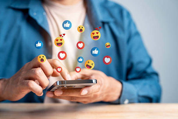 istock Social media digital content. User interacting with smartphone emoji reactions appear. online engagement, emotional feedback, and digital communication. 2234934579