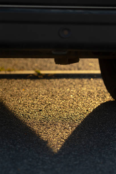 istock A cars shadow is cast on the asphalt surface during a beautiful sunset 2234936053