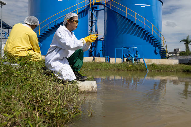istock Water quality test, Environmental engineers wearing PPE sample inspect water quality , Industrial and environment 2234943295